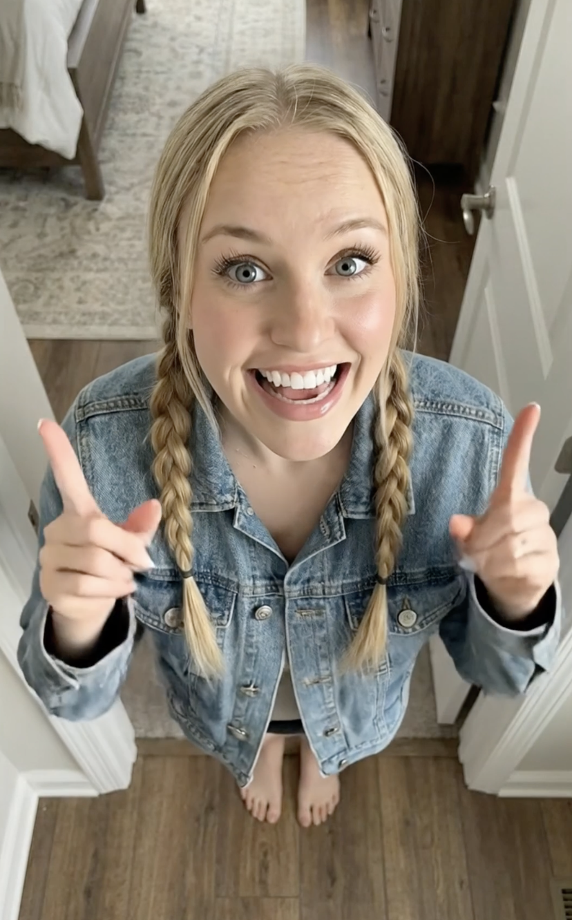 Woman looking into the camera and gesturing enthusiastically